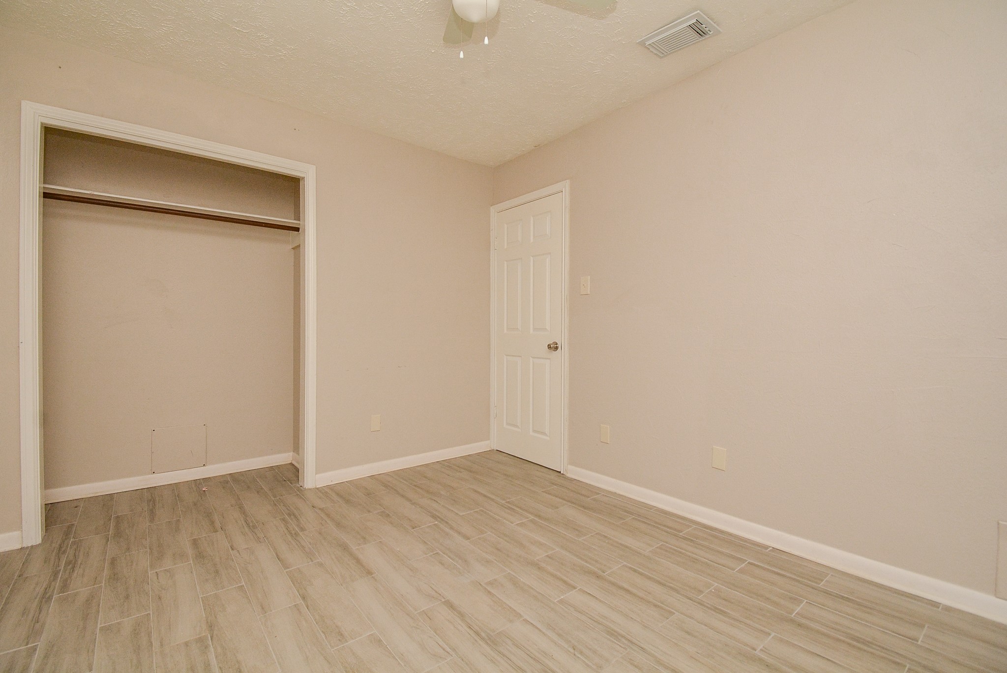 22906 Indian Ridge Drive Katy, TX 77450 - Photo 14 of 26 a view of an empty room with wooden floor