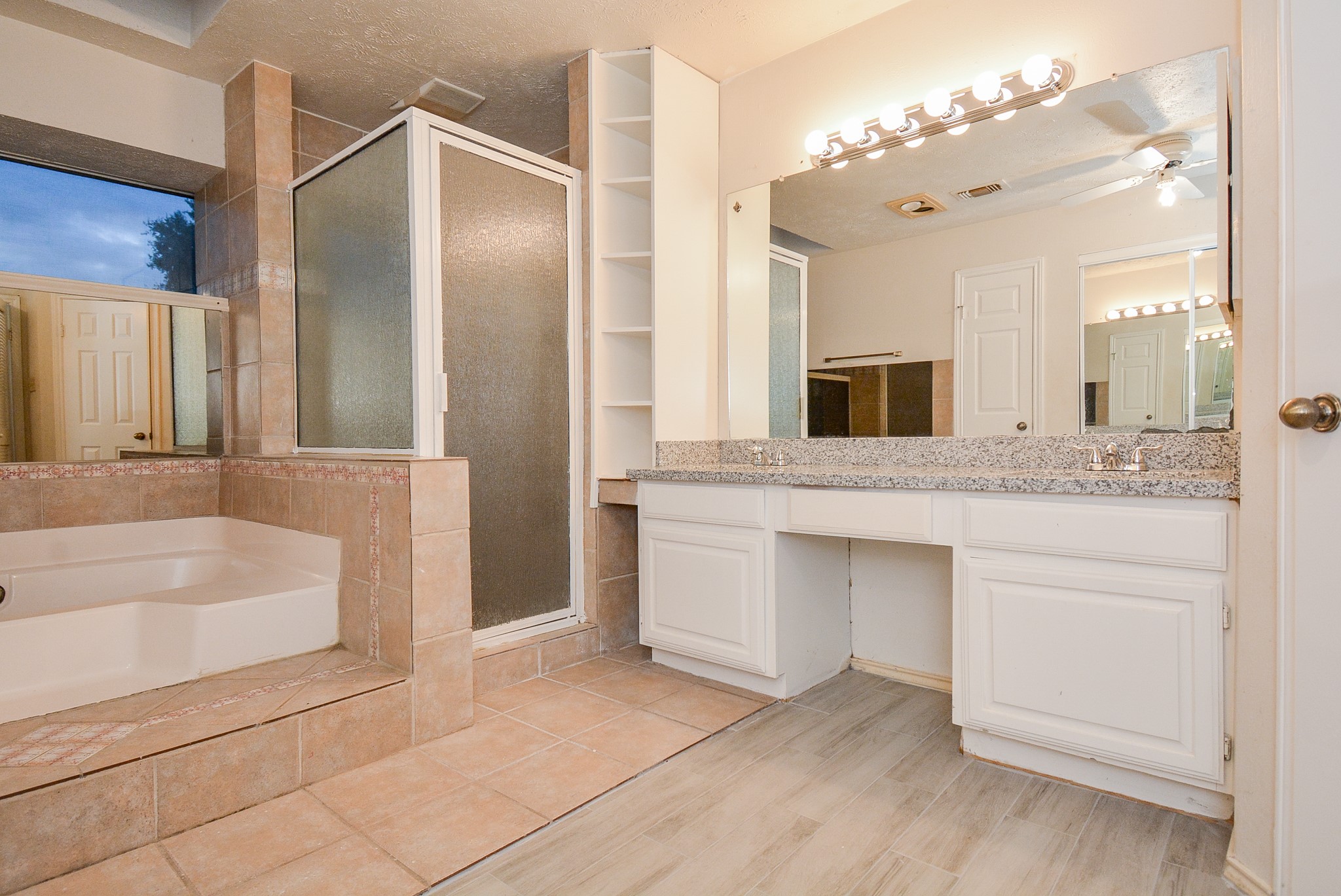 22906 Indian Ridge Drive Katy, TX 77450 - Photo 17 of 26 a bathroom with a granite countertop sink mirror and bathtub