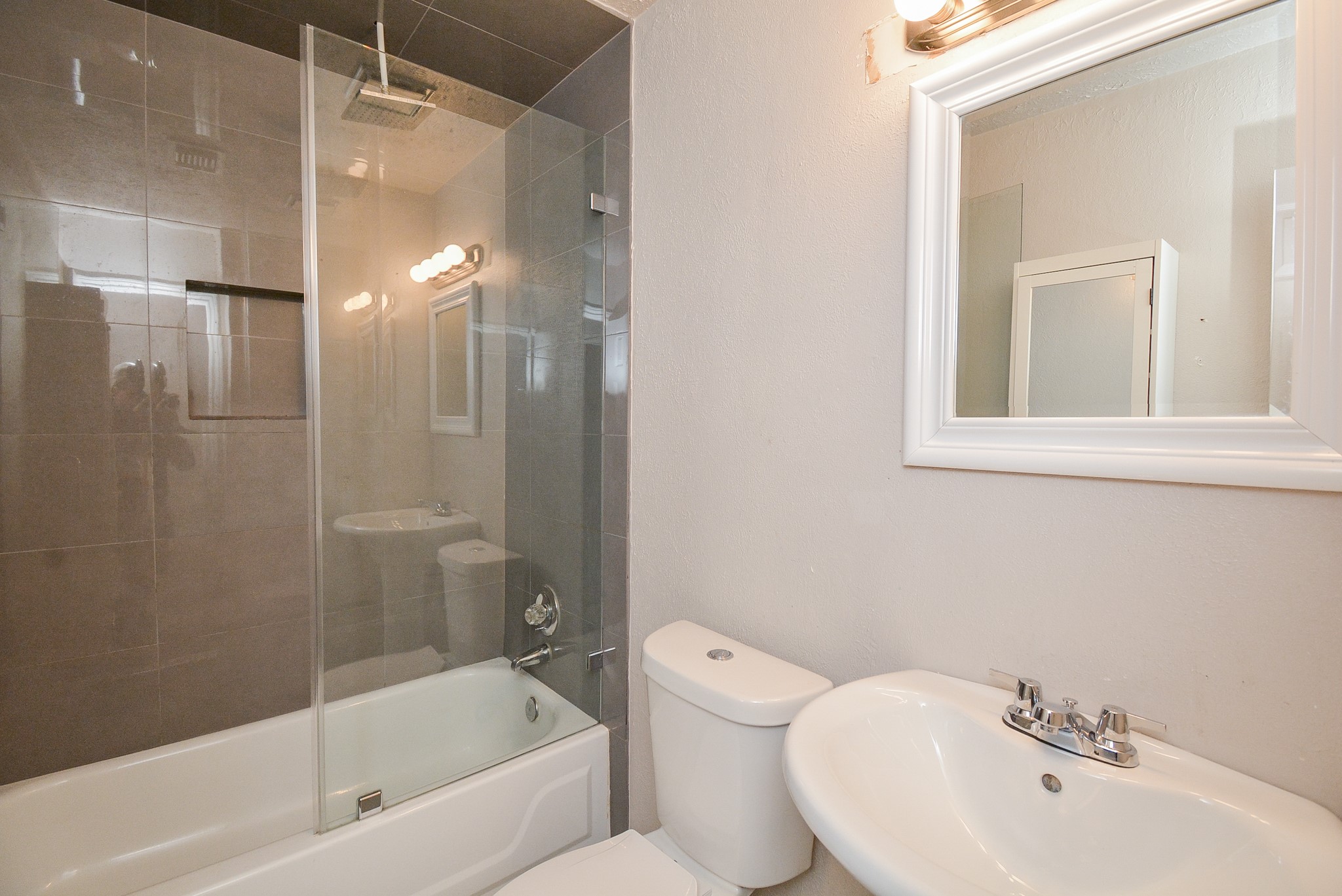 22906 Indian Ridge Drive Katy, TX 77450 - Photo 23 of 26 a bathroom with a bathtub shower sink vanity and toilet