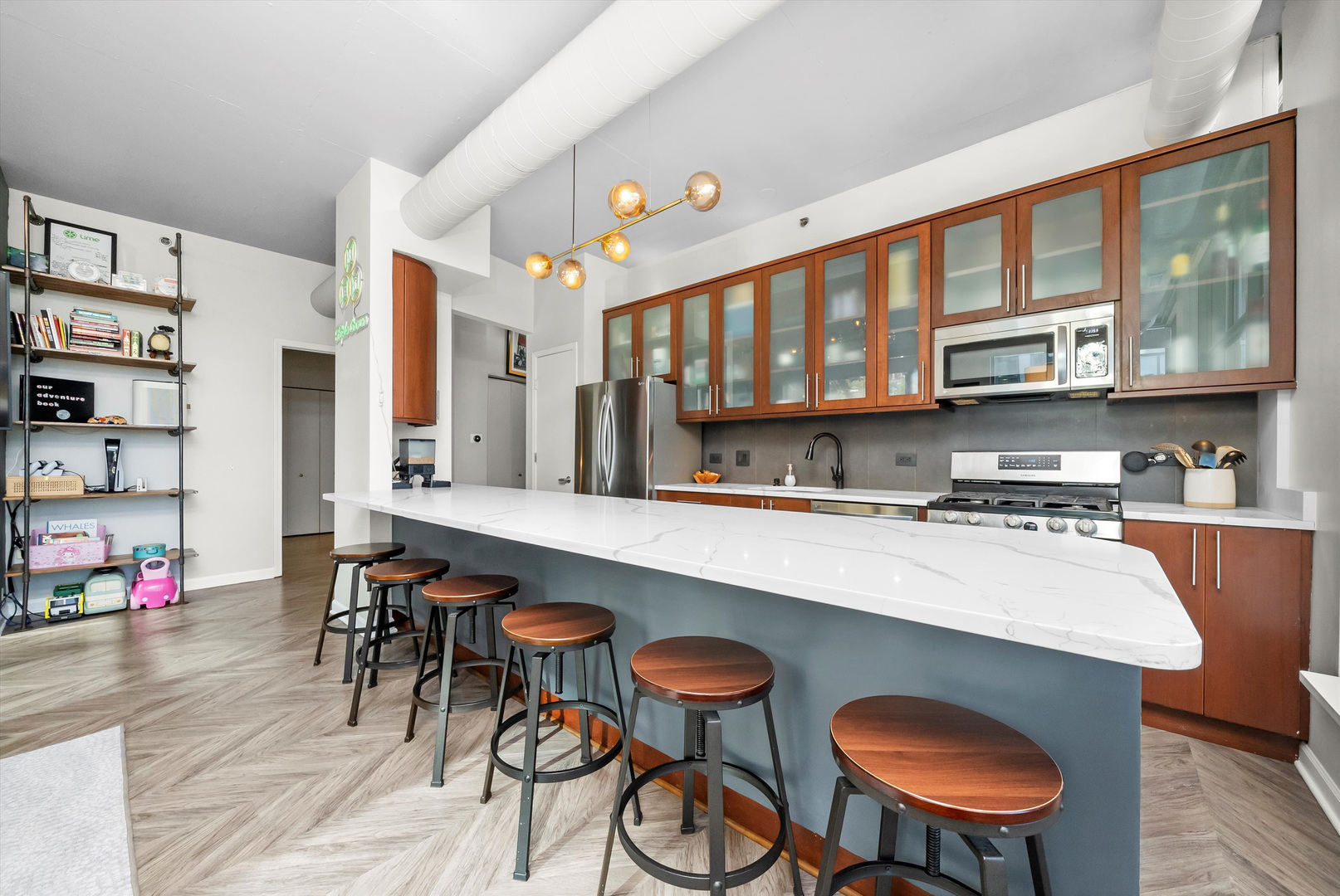 125 East 13th Street, Unit 601 Chicago, IL 60605 - Photo 11 of 25 a kitchen with stainless steel appliances granite countertop a table chairs stove and a sink