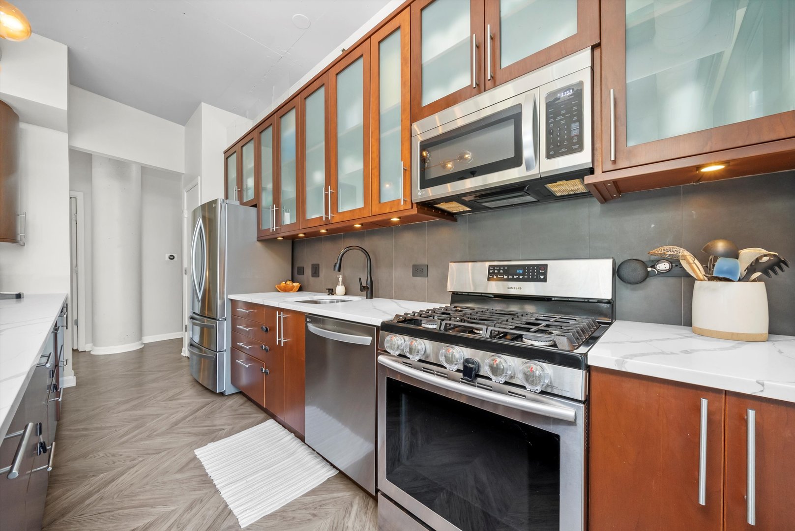 125 East 13th Street, Unit 601 Chicago, IL 60605 - Photo 12 of 25 a kitchen with stainless steel appliances granite countertop a stove and a sink