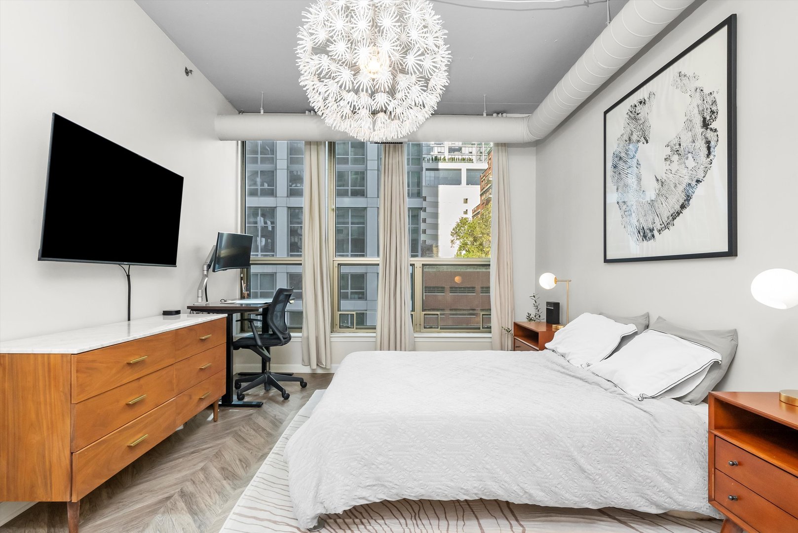 125 East 13th Street, Unit 601 Chicago, IL 60605 - Photo 14 of 25 a bedroom with a bed and a flat screen tv