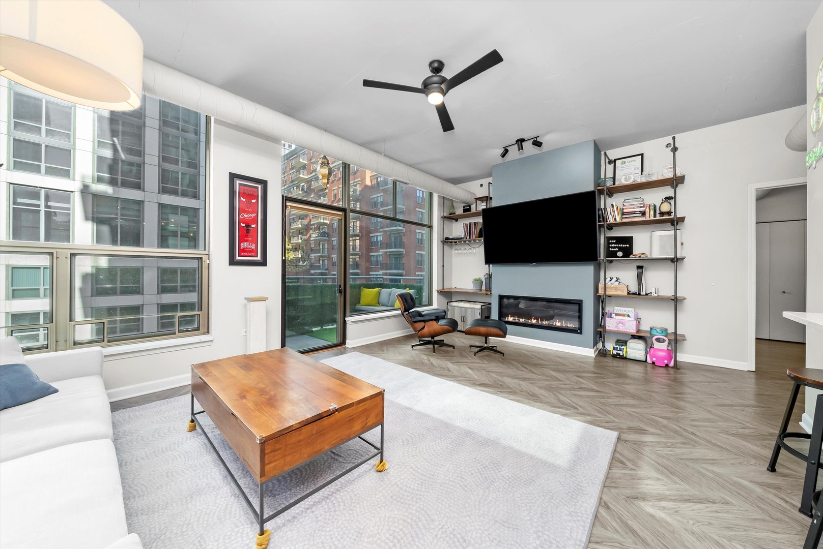 125 East 13th Street, Unit 601 Chicago, IL 60605 - Photo 5 of 25 a living room with furniture a flat screen tv and a large window