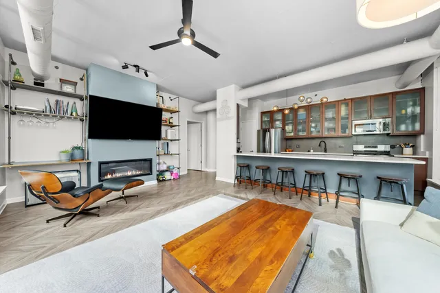 a living room with furniture a pool table and a flat screen tv