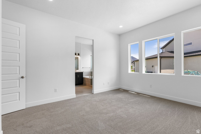 43 South Crimson Way, Unit 311 Mapleton, UT 84664 - Photo 14 of 28 Carpeted room featuring a white paneled door, recessed lighting, and three tall windows