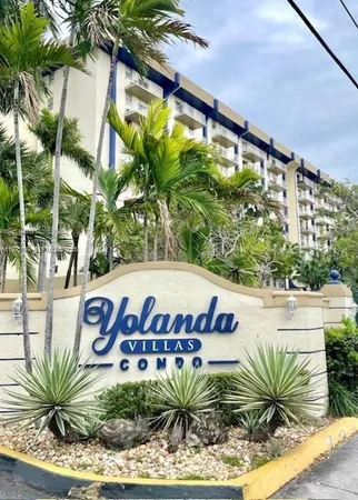a view of sign board with potted plants
