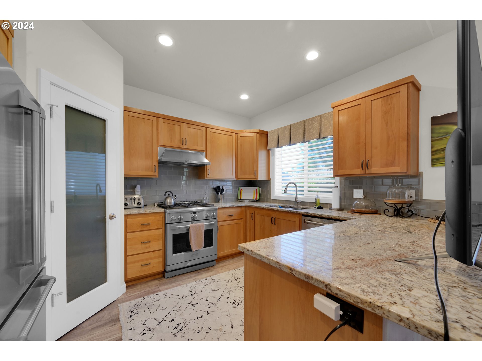 1550 Kellogg Road Springfield, OR 97477 - Photo 10 of 27 a kitchen with stainless steel appliances granite countertop wooden cabinets a stove top oven a sink and dishwasher