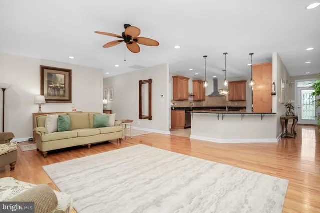 a living room with furniture and kitchen view