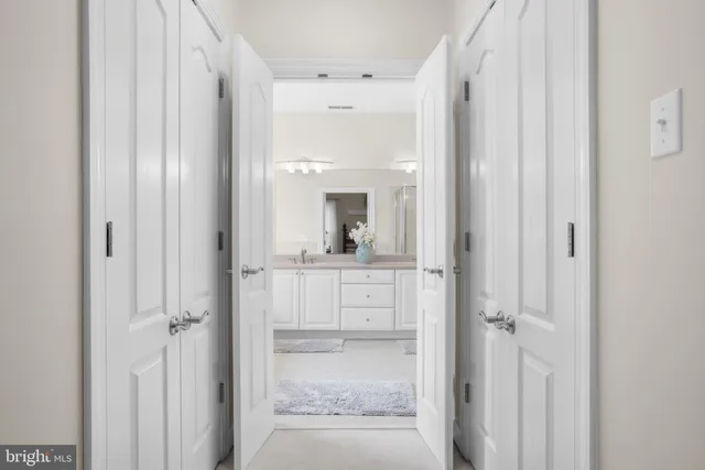a bathroom with a glass door shower and sink