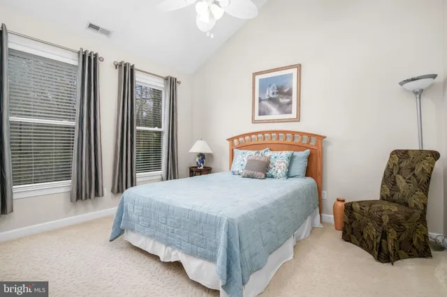 a bedroom with a bed and a lamp