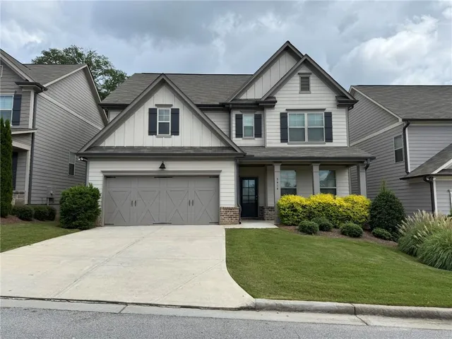 a front view of a house with a yard and garage