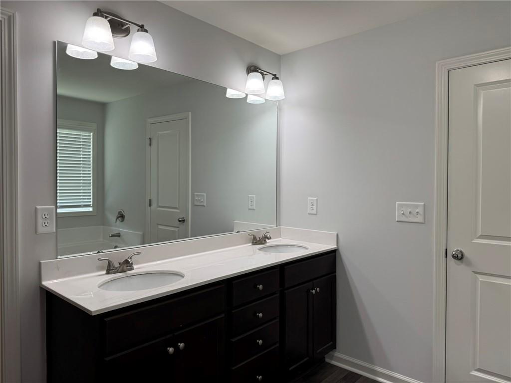 5414 Long Branch Way Flowery Branch, GA 30542 - Photo 23 of 37 a bathroom with a double vanity sink and a mirror