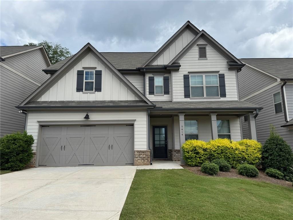 5414 Long Branch Way Flowery Branch, GA 30542 - Photo 3 of 37 a front view of a house with a yard and garage