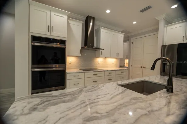 a kitchen with granite countertop a stove and a sink