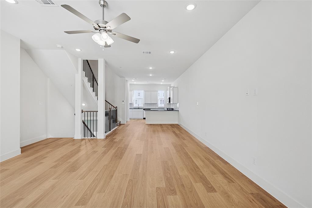 809 Concan Drive Plano, TX 75075 - Photo 14 of 40 Unfurnished living room featuring ceiling fan and light wood-type flooring