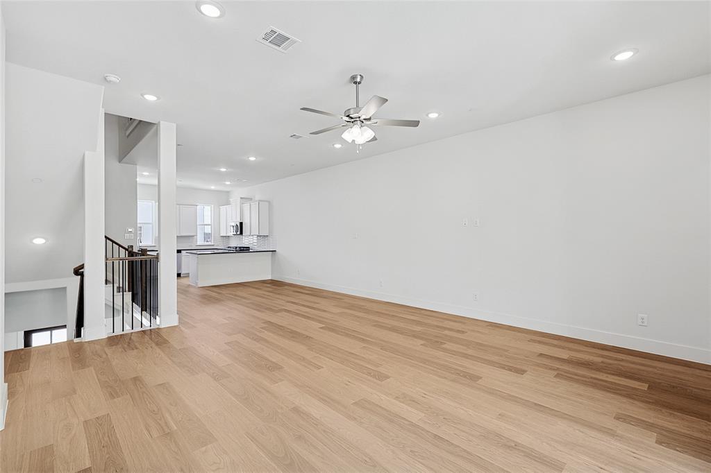 809 Concan Drive Plano, TX 75075 - Photo 15 of 40 Unfurnished living room with light hardwood / wood-style flooring and ceiling fan