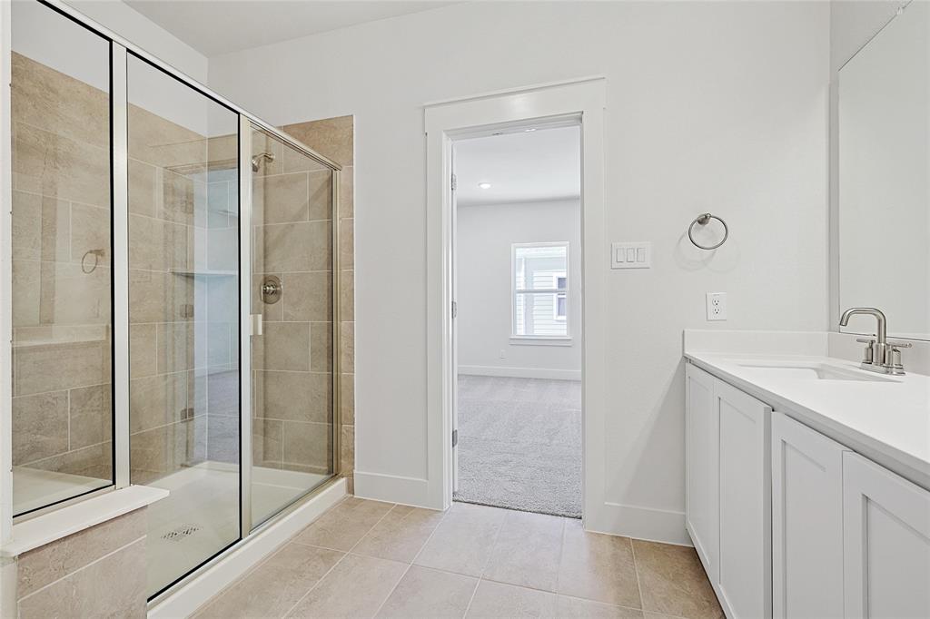 809 Concan Drive Plano, TX 75075 - Photo 20 of 40 Bathroom with tile patterned floors, walk in shower, and vanity
