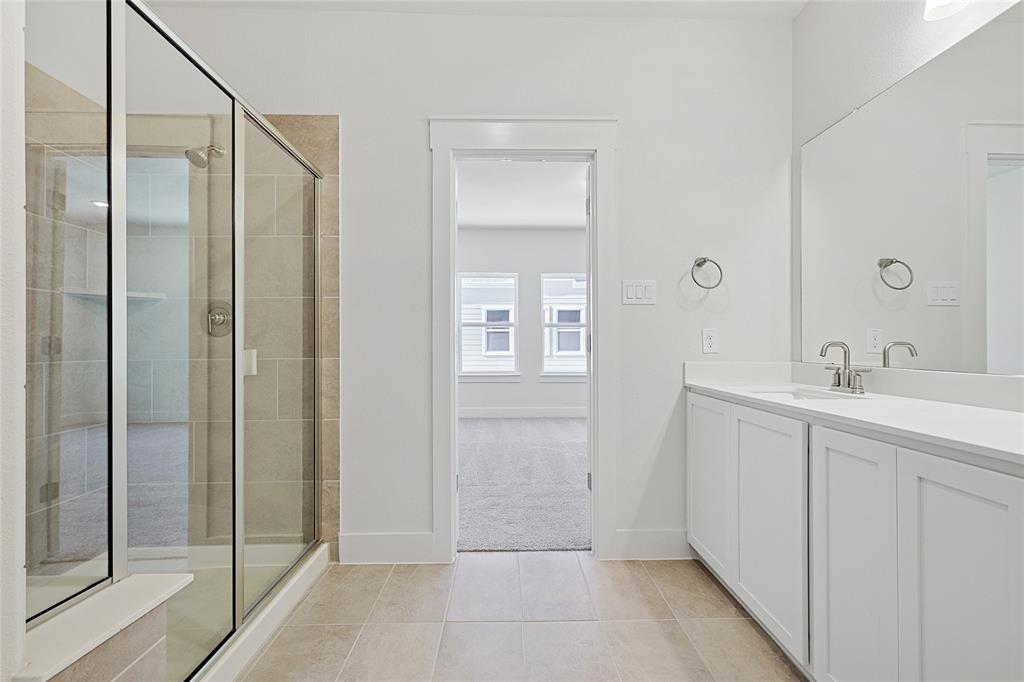809 Concan Drive Plano, TX 75075 - Photo 22 of 40 Bathroom with an enclosed shower, vanity, and tile patterned flooring
