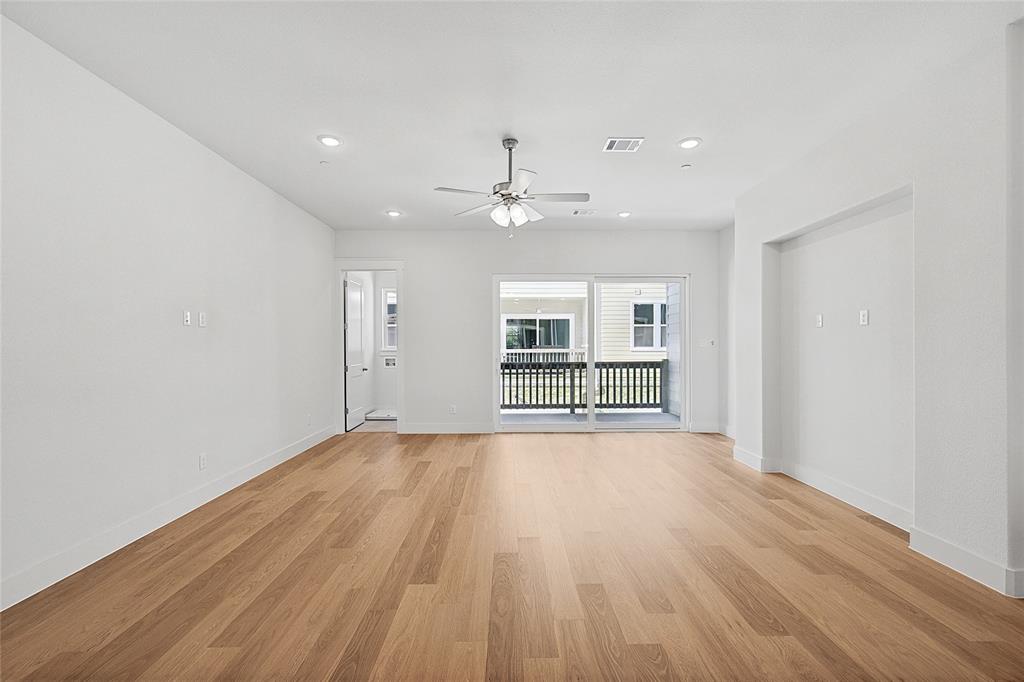 809 Concan Drive Plano, TX 75075 - Photo 9 of 40 Unfurnished living room with light wood-type flooring and ceiling fan