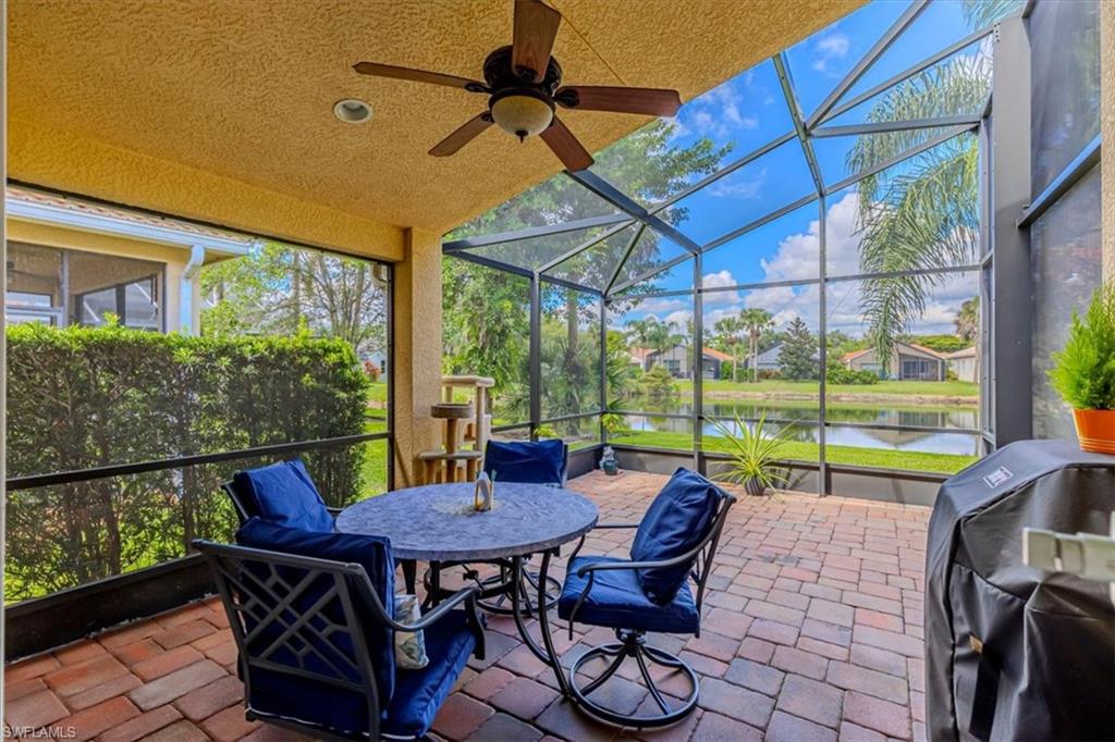 1630 Triangle Palm Terrace Naples, FL 34119 - Photo 21 of 24 a view of a patio with a table chairs and a backyard