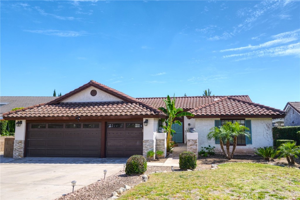 9841 Golden Arrow Lane Rancho Cucamonga, CA 91701 - Photo 1 of 53 a front view of a house with garden