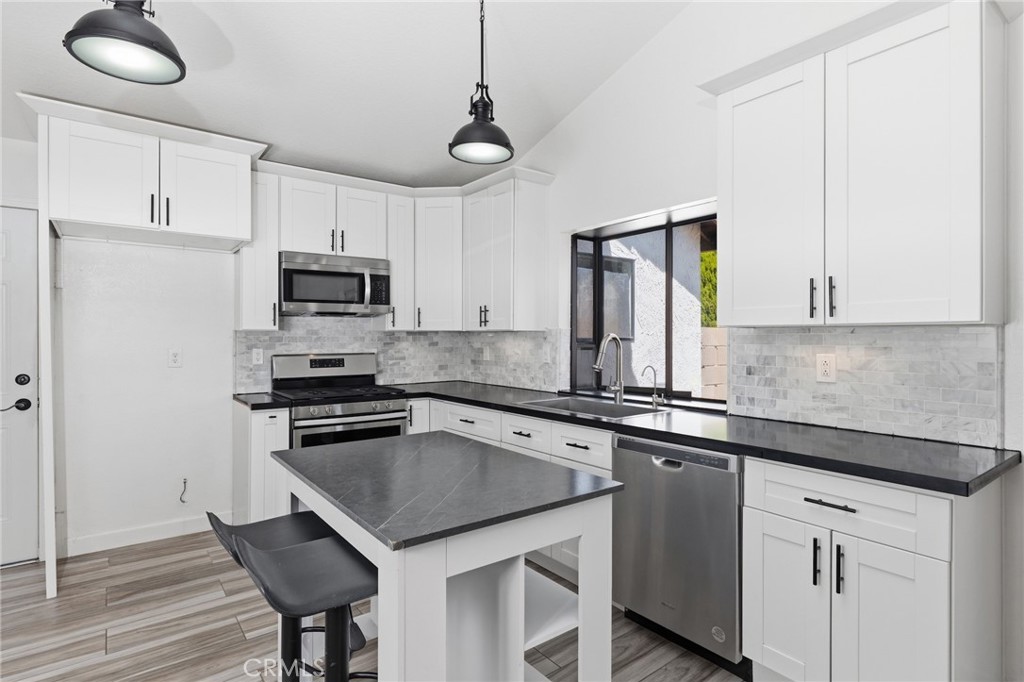 9841 Golden Arrow Lane Rancho Cucamonga, CA 91701 - Photo 12 of 53 a kitchen with appliances cabinets a sink and a stove