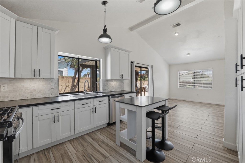 9841 Golden Arrow Lane Rancho Cucamonga, CA 91701 - Photo 13 of 53 a kitchen with sink cabinets and wooden floor