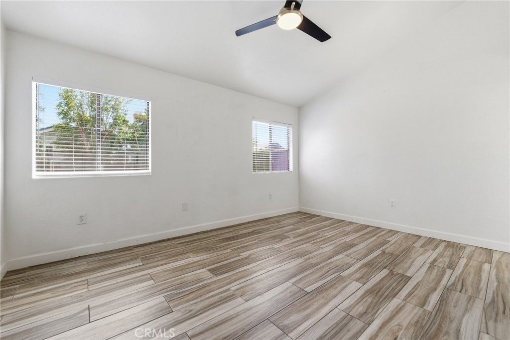 9841 Golden Arrow Lane Rancho Cucamonga, CA 91701 - Photo 16 of 53 a view of an empty room with wooden floor and a window