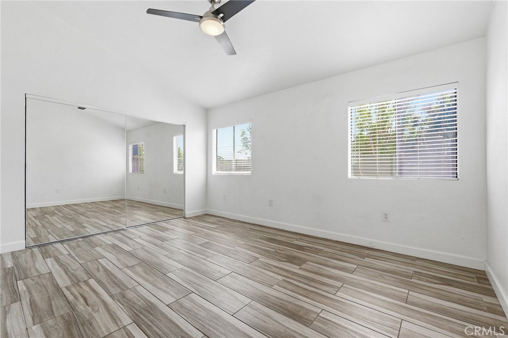 9841 Golden Arrow Lane Rancho Cucamonga, CA 91701 - Photo 17 of 53 a view of an empty room with a window and wooden floor