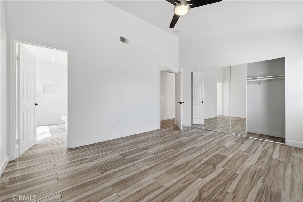 9841 Golden Arrow Lane Rancho Cucamonga, CA 91701 - Photo 18 of 53 a view of an empty room with wooden floor