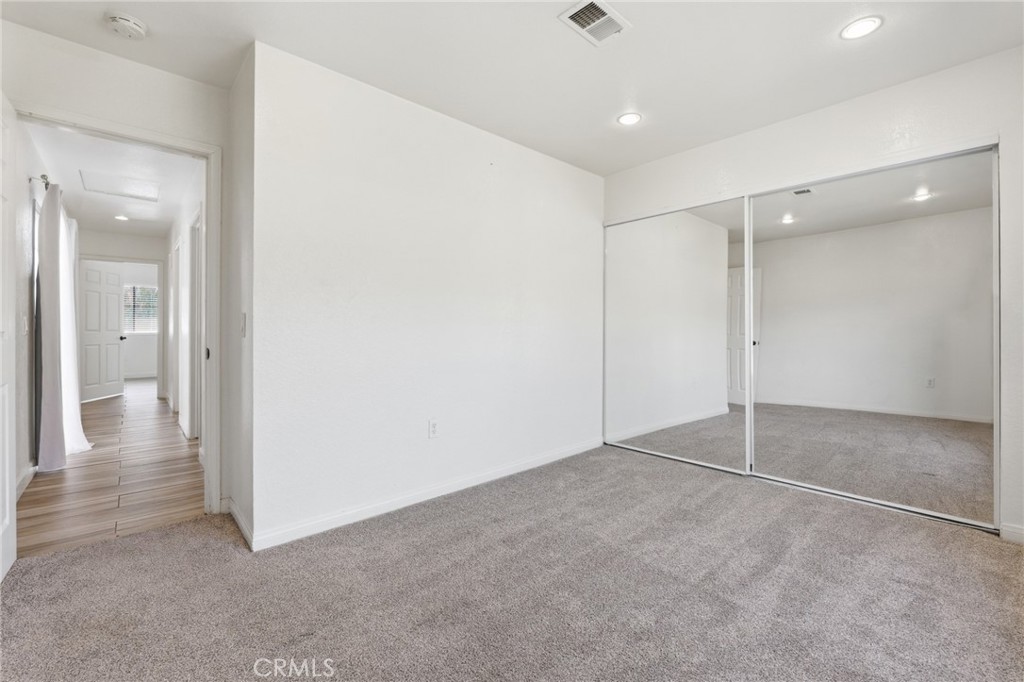 9841 Golden Arrow Lane Rancho Cucamonga, CA 91701 - Photo 21 of 53 an empty room with an entryway and a hallway
