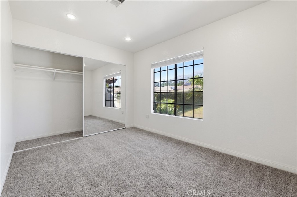 9841 Golden Arrow Lane Rancho Cucamonga, CA 91701 - Photo 22 of 53 an empty room with windows