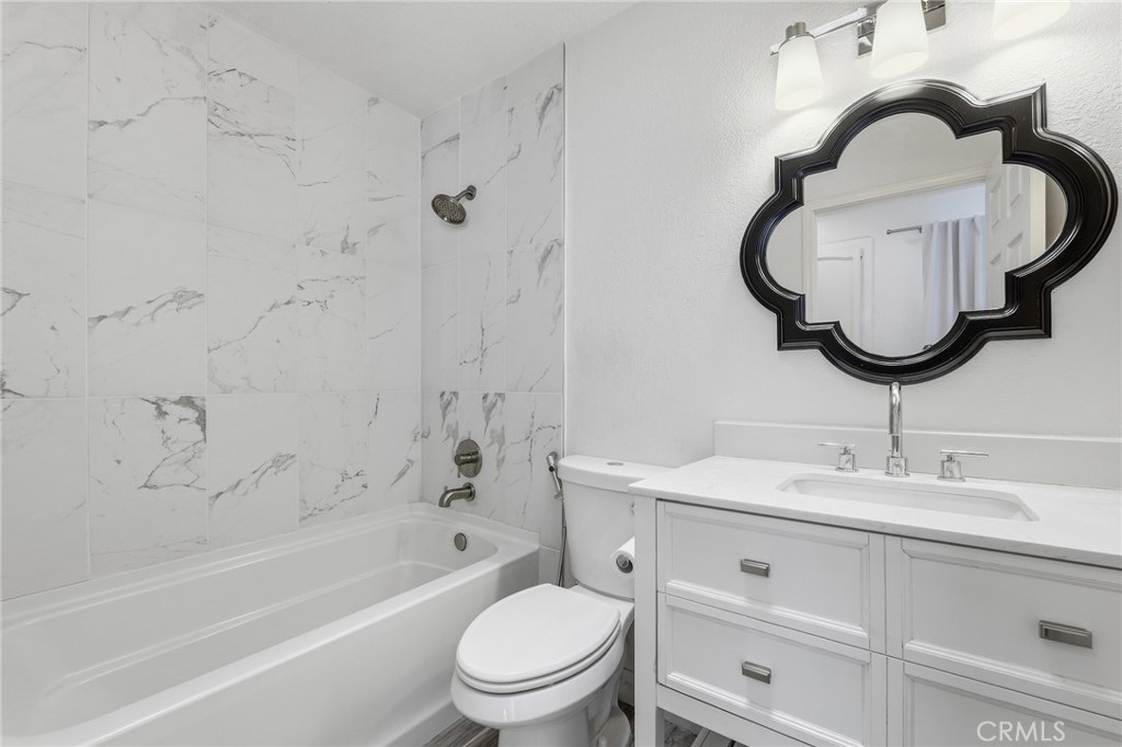 9841 Golden Arrow Lane Rancho Cucamonga, CA 91701 - Photo 23 of 53 a bathroom with a sink a toilet and a bathtub