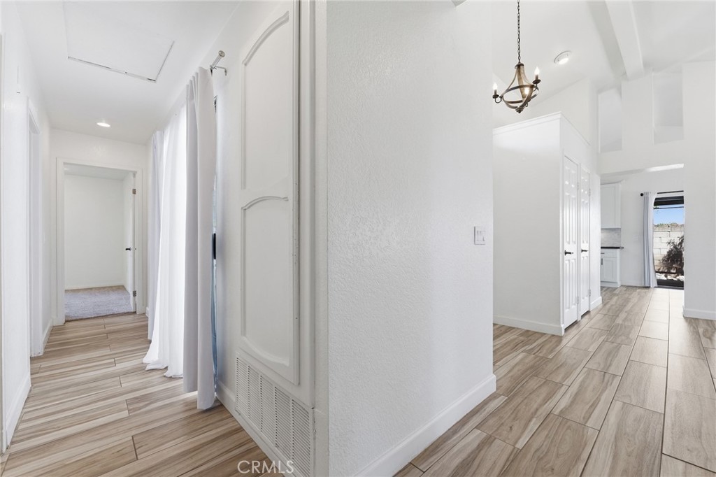 9841 Golden Arrow Lane Rancho Cucamonga, CA 91701 - Photo 27 of 53 a view of a hallway with wooden floor and staircase
