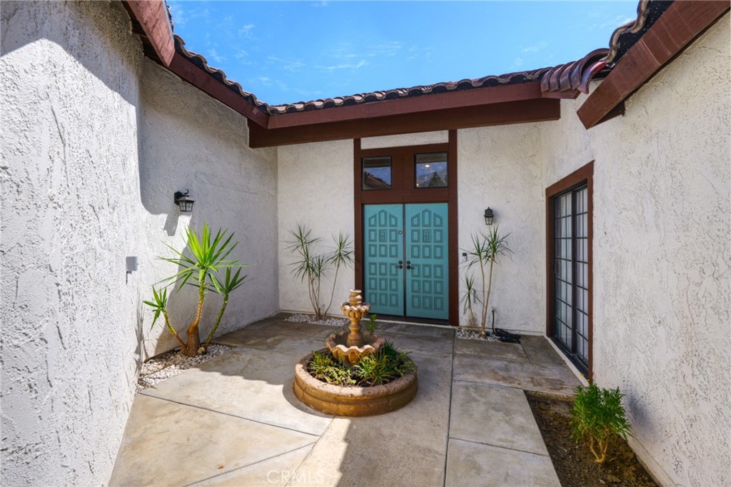 9841 Golden Arrow Lane Rancho Cucamonga, CA 91701 - Photo 3 of 53 a front view of a house with a garden
