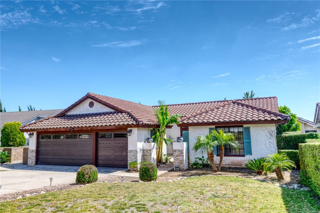 9841 Golden Arrow Lane Rancho Cucamonga, CA 91701 - Photo 44 of 53 a front view of a house with garden