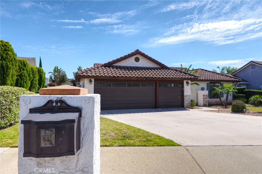 9841 Golden Arrow Lane Rancho Cucamonga, CA 91701 - Photo 52 of 53 a front view of a house with a garden
