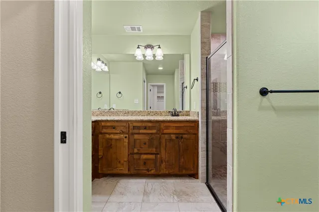 a bathroom with a double vanity sink and a mirror