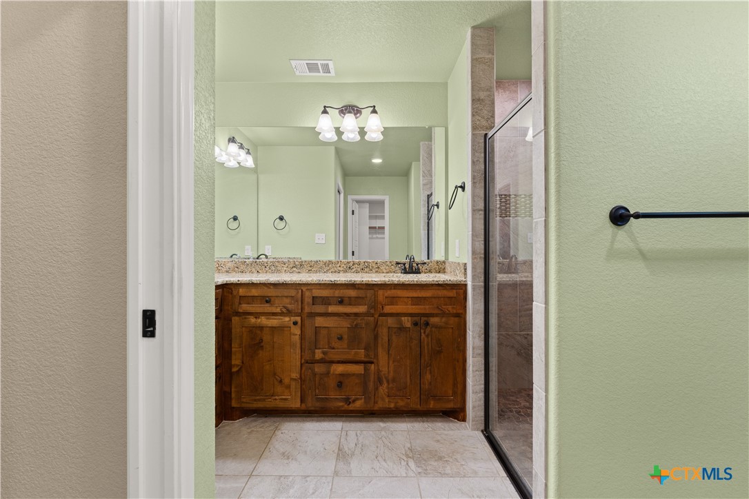 250 Old Waco Road Gatesville, TX 76528 - Photo 11 of 23 a bathroom with a double vanity sink and a mirror