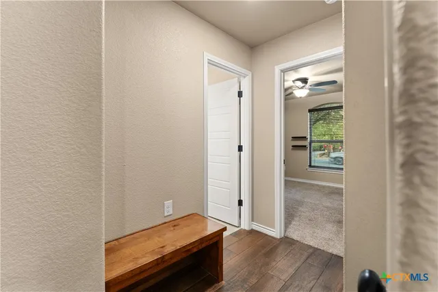 a view of a room with wooden floor