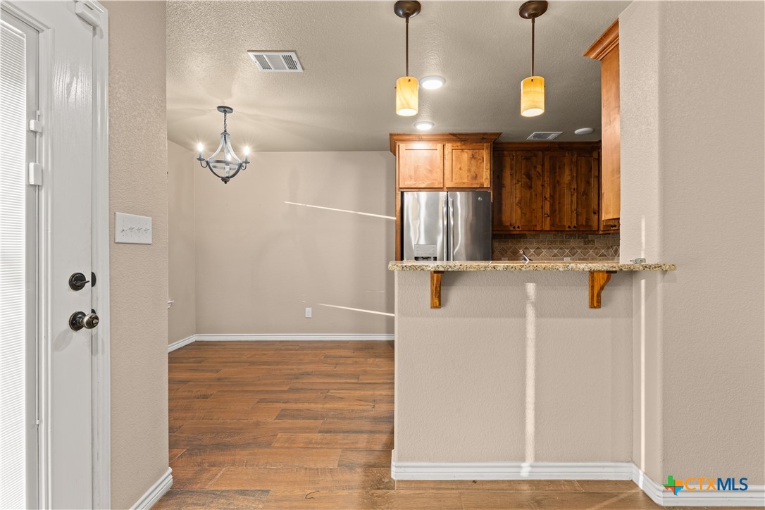 250 Old Waco Road Gatesville, TX 76528 - Photo 5 of 23 a view of a hallway with a white cabinet and a window