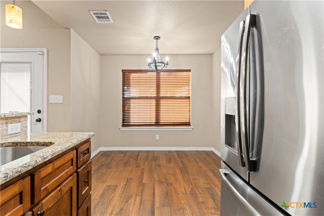 250 Old Waco Road Gatesville, TX 76528 - Photo 7 of 23 a bathroom with a granite countertop sink a mirror and a window