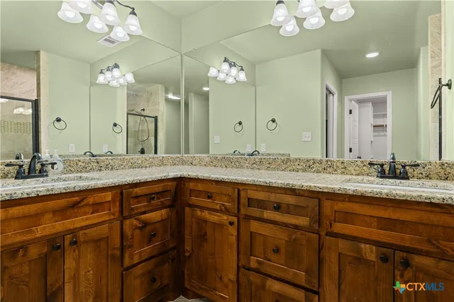 a bathroom with a double vanity sink and a mirror