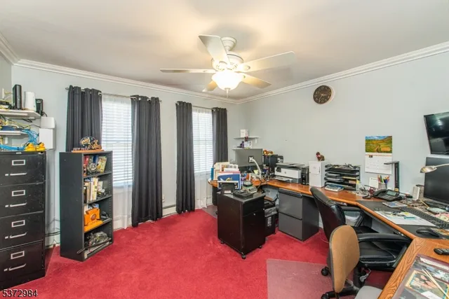 a view of a workspace with furniture and a window