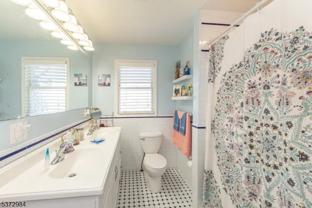 a bathroom with a sink toilet a shower and a mirror