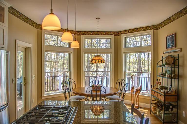 7 Harbor Ridge Road Mashpee, MA 02649 - Photo 18 of 26 a dining room with furniture a chandelier and wooden floor