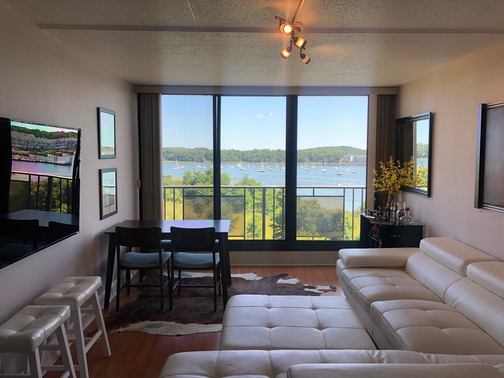 73 Broad Reach, Unit M55C Weymouth, MA 02191 - Photo 2 of 18 a living room with furniture and a large window