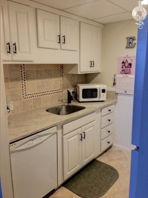 73 Broad Reach, Unit M55C Weymouth, MA 02191 - Photo 6 of 18 a kitchen with stainless steel appliances white cabinets and white appliances