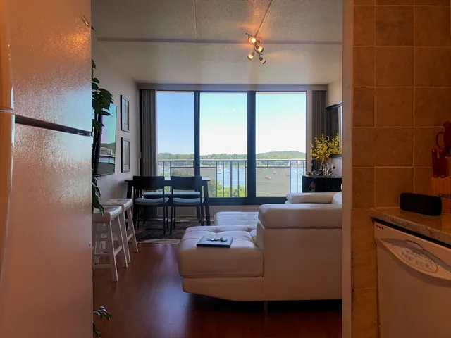 a living room with furniture and a floor to ceiling window