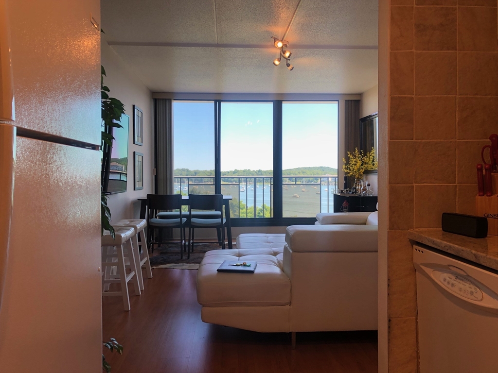 73 Broad Reach, Unit M55C Weymouth, MA 02191 - Photo 7 of 18 a living room with furniture and a floor to ceiling window